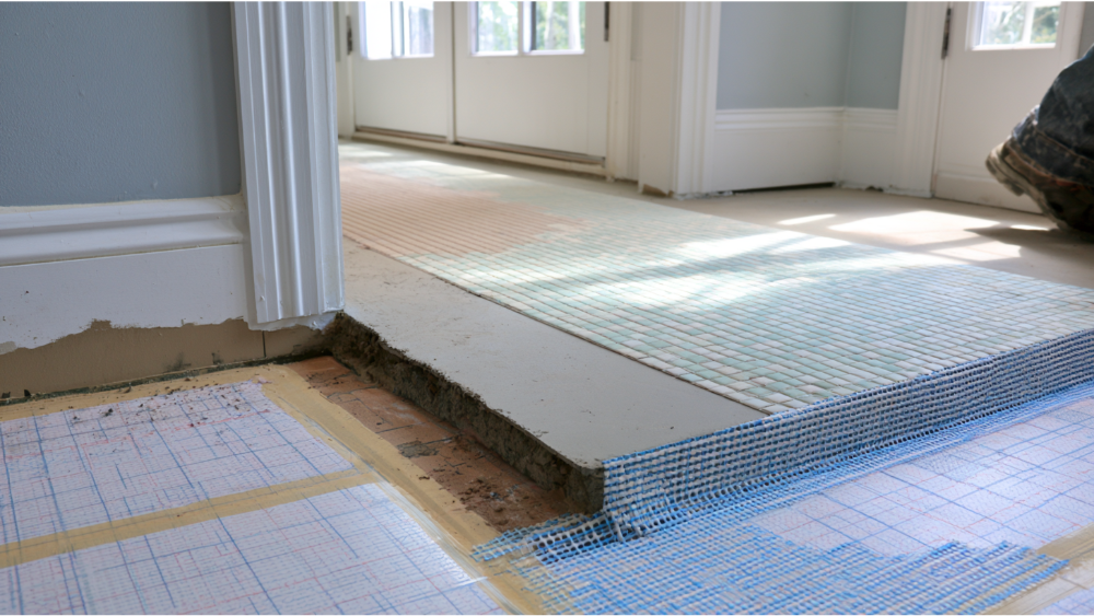 Close-up of cement backer board, waterproof membrane, and uncoupling membrane installed before laying floor and shower tiles.